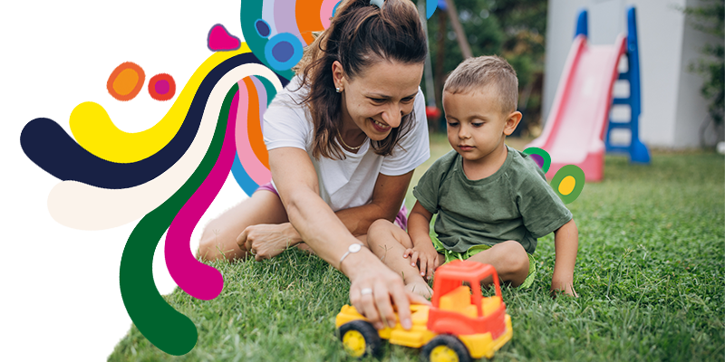Mother and son playing with a toy truck