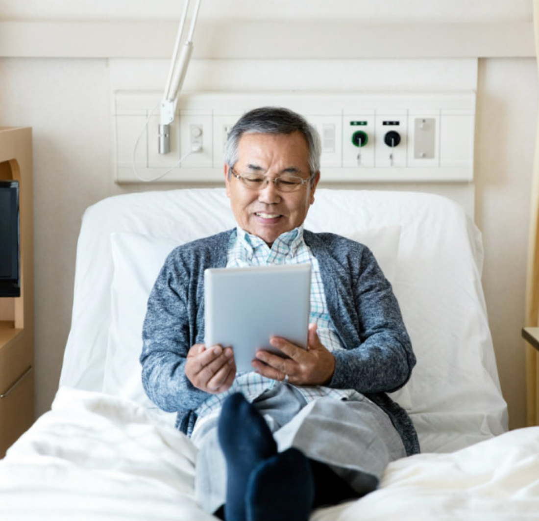 Man in hospital bed smiling