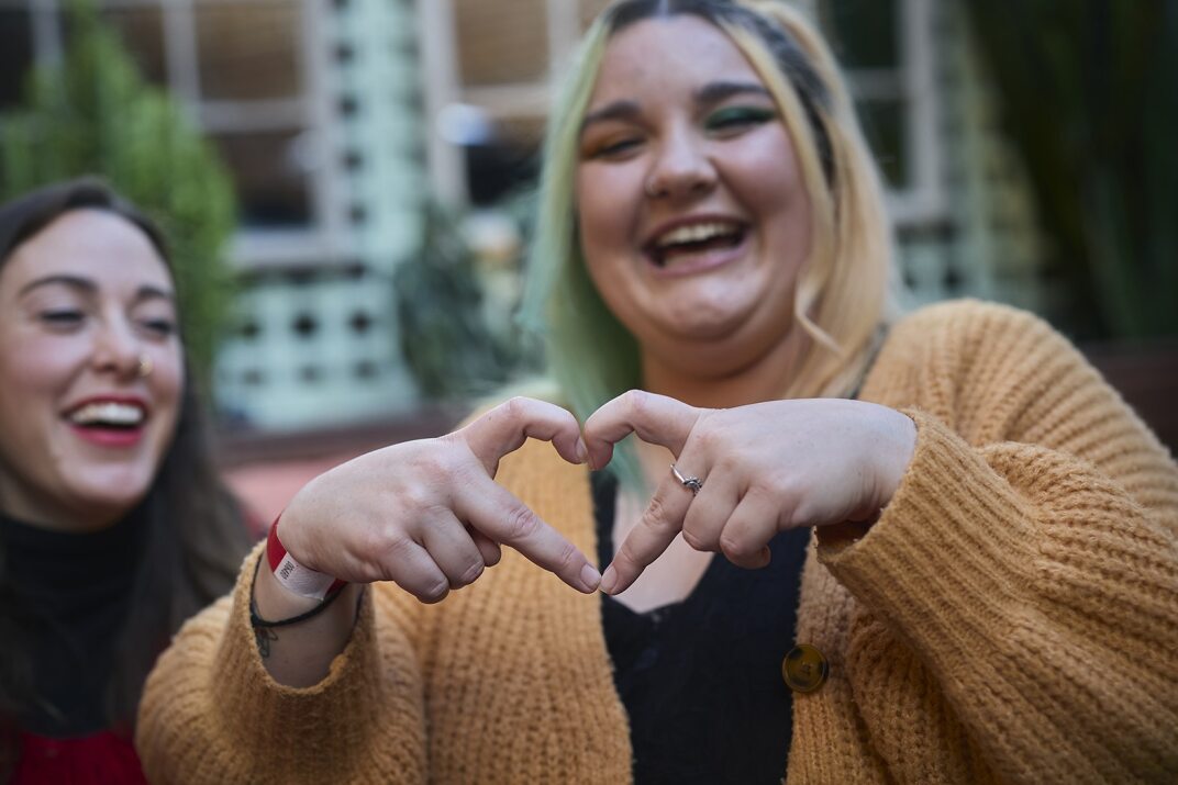 Women making heart shape with her fingers 