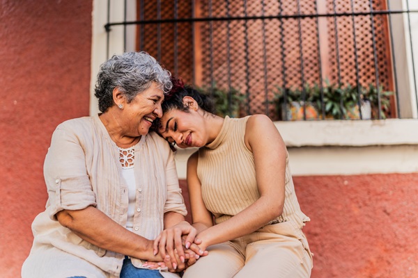 Mother and daughter talking outside their house